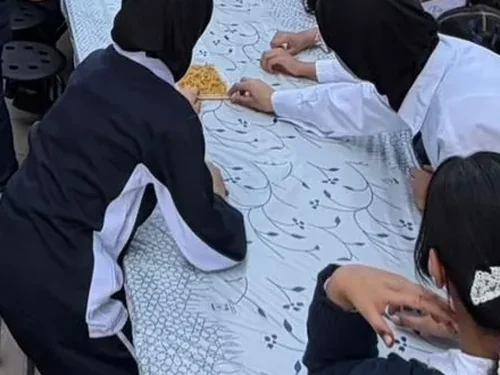Children at a Treasure Island craft table during an outdoor school event