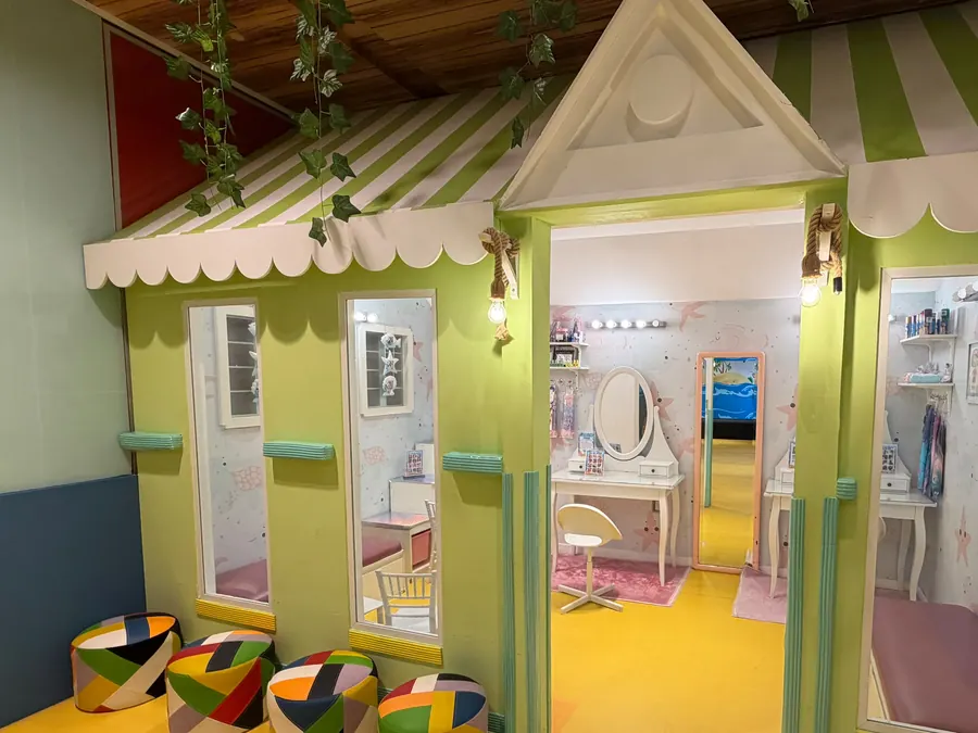 The role-play village houses with striped awnings