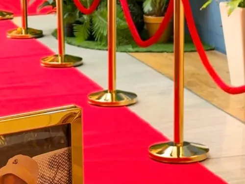 Gold frames and velvet rope along the walk &mdash; Royal Birthday at Treasure Island Dubai
